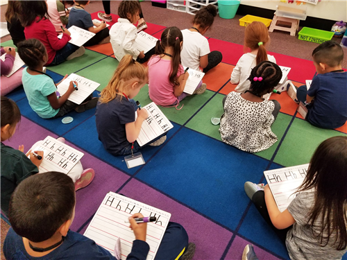 students practice writing letters